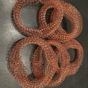 Half a dozen copper coils stacked across the image.