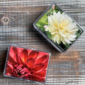 Two decks of cards rest on a wooden grain background.